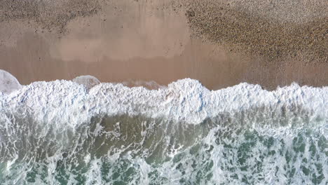 Waves-crashing-on-a-sandy-beach-mediterranean-sea-aerial-top-shot